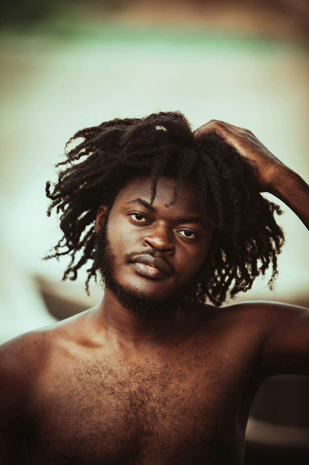 Studio portrait of a young Afro-Brazilian man with a friendly smile