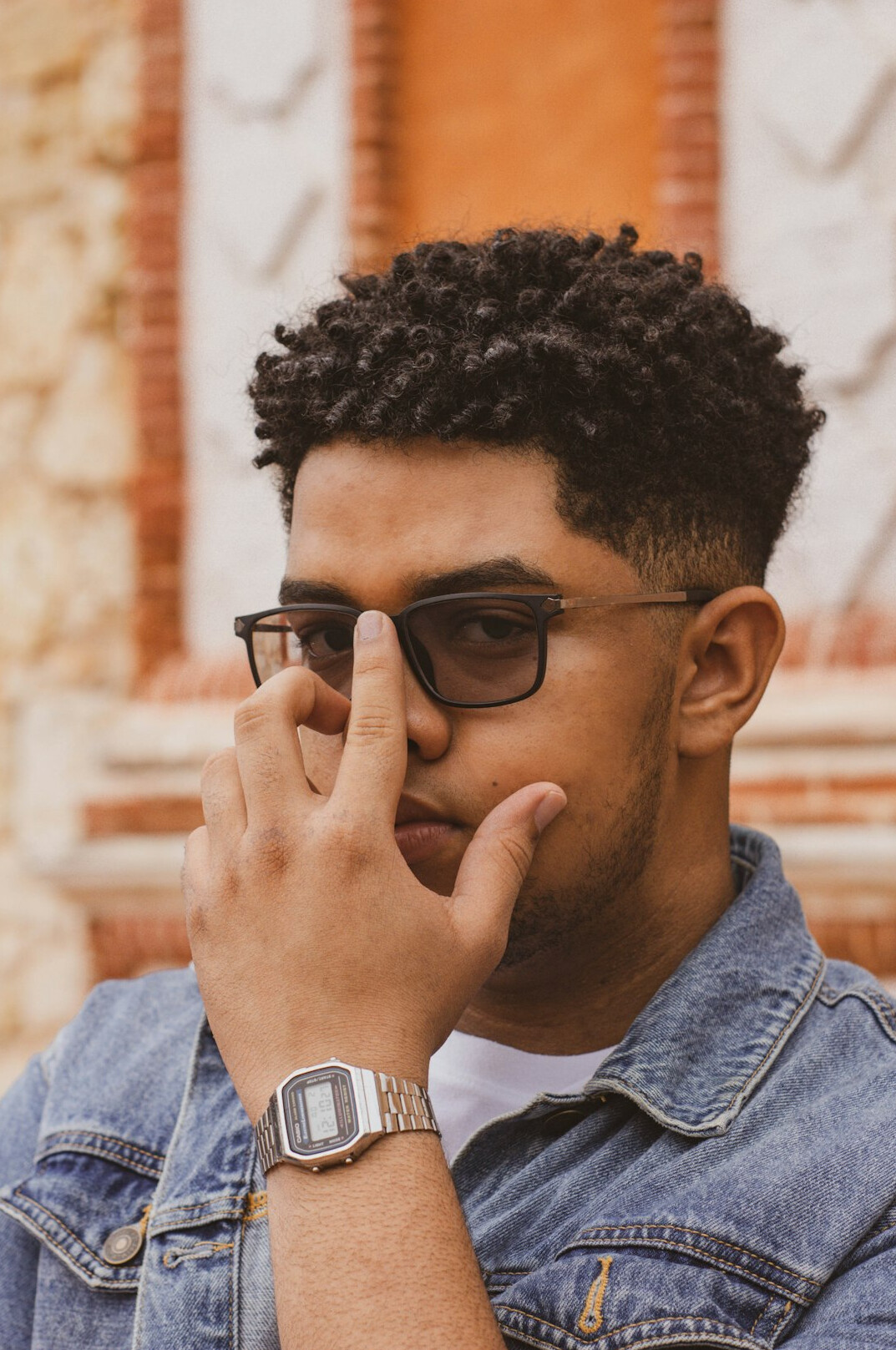 Studio portrait of a Brazilian man in his thirties wearing glasses